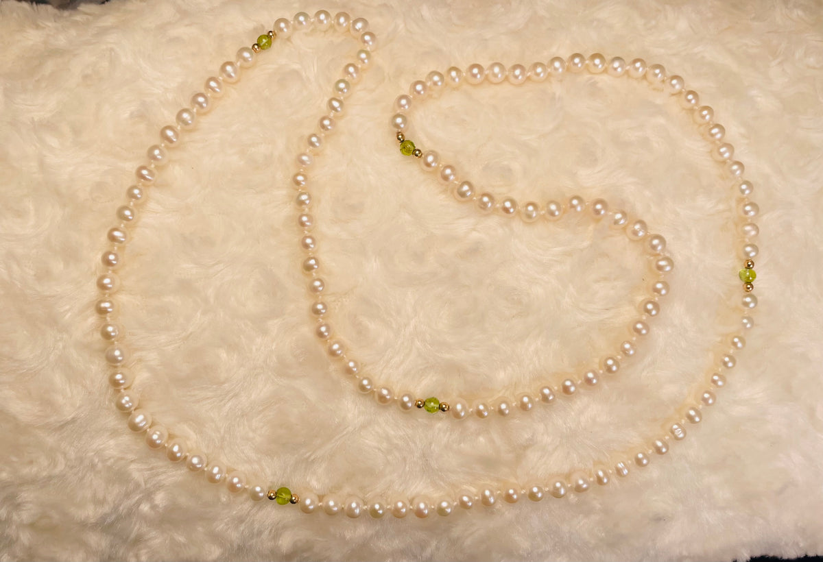 Freshwater pearl and peridot necklace on white background
