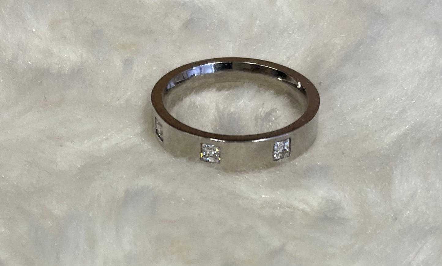 Flat Court Band with three Princess Cut Cubic Zirconicas Ring