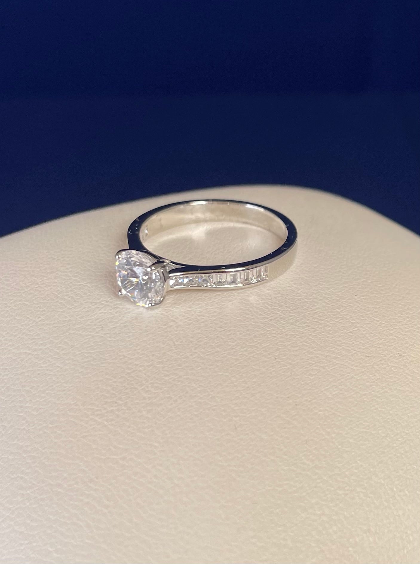 Rhodium-Plated Silver Brilliant Cut Cubic Zirconia Solitaire With Baguette CZ on Shoulder
