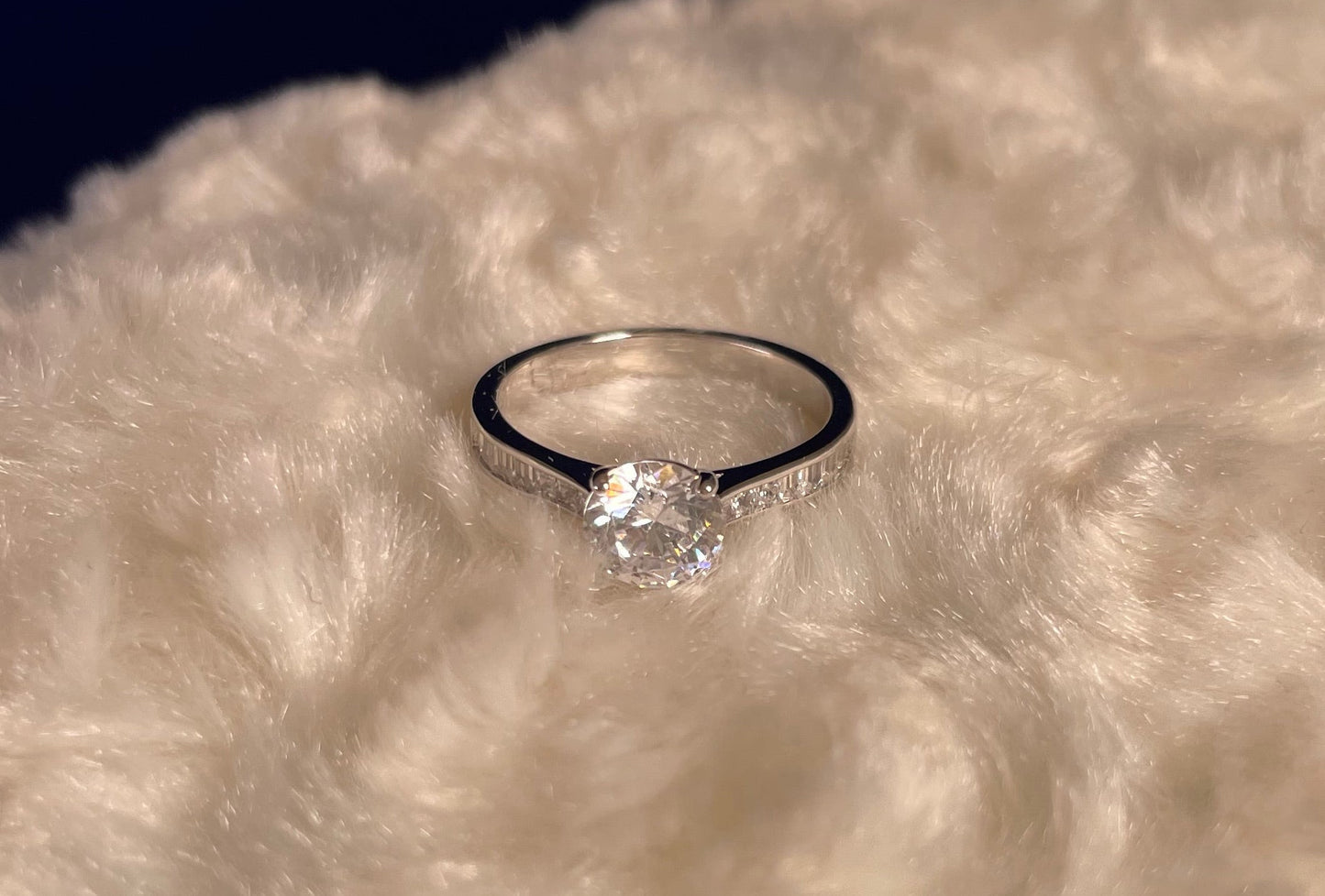 Rhodium-Plated Silver Brilliant Cut Cubic Zirconia Solitaire With Baguette CZ on Shoulder