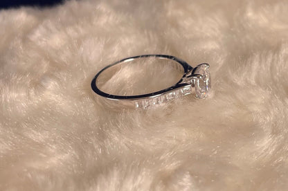 Rhodium-Plated Silver Brilliant Cut Cubic Zirconia Solitaire With Baguette CZ on Shoulder