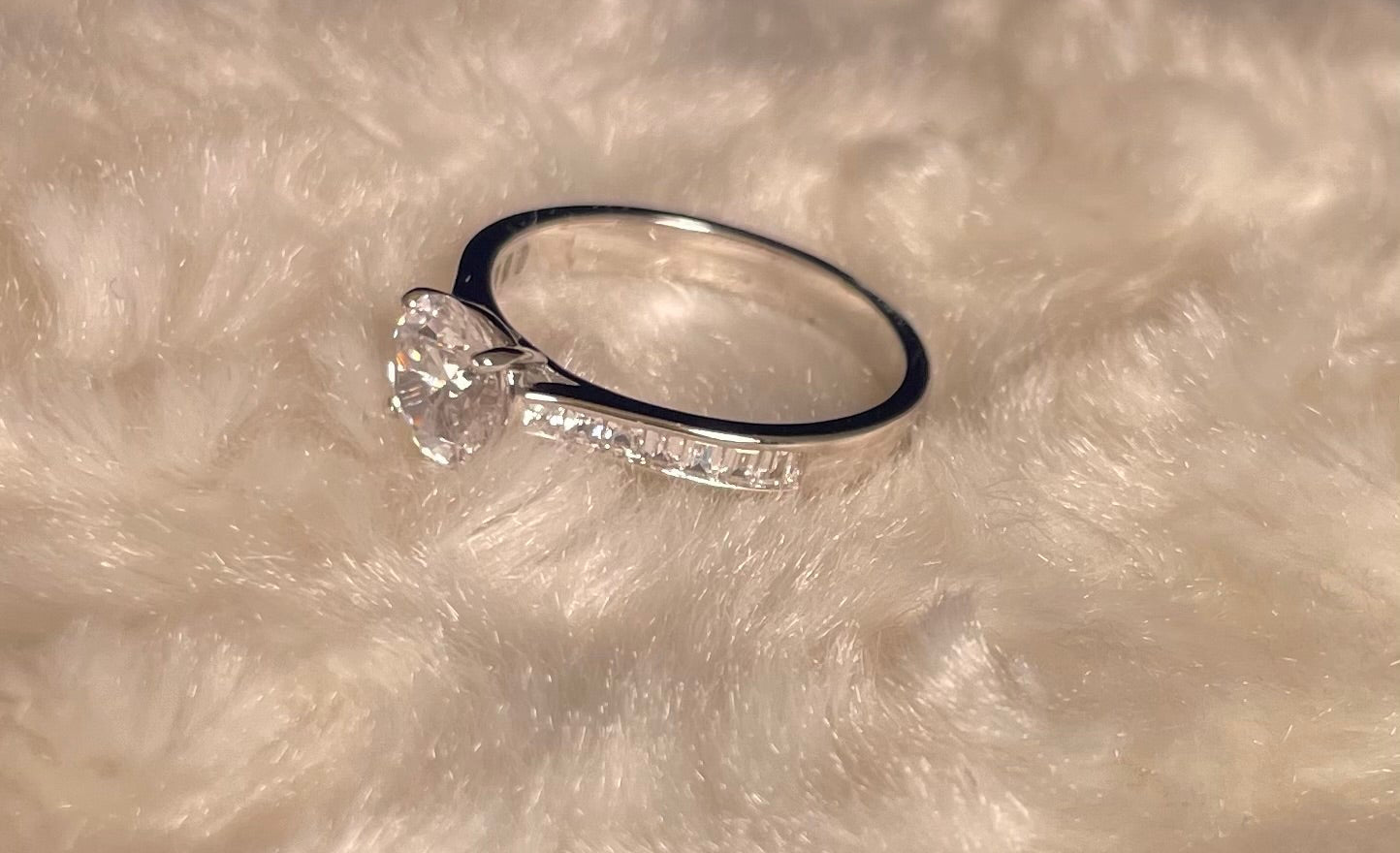 Rhodium-Plated Silver Brilliant Cut Cubic Zirconia Solitaire With Baguette CZ on Shoulder