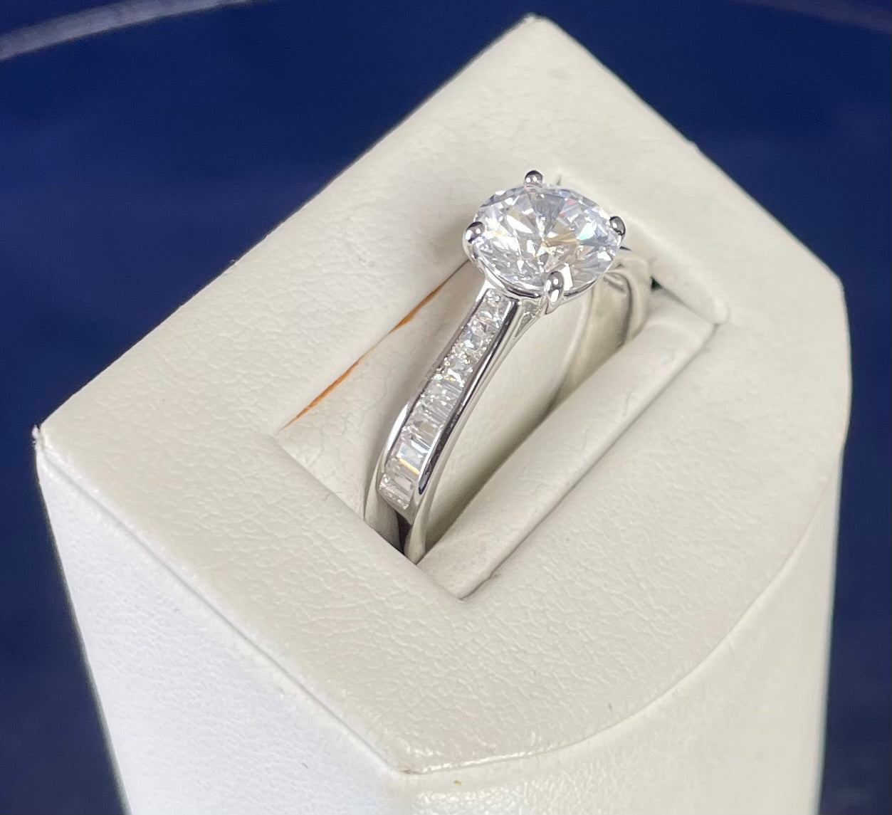 Rhodium-Plated Silver Brilliant Cut Cubic Zirconia Solitaire With Baguette CZ on Shoulder